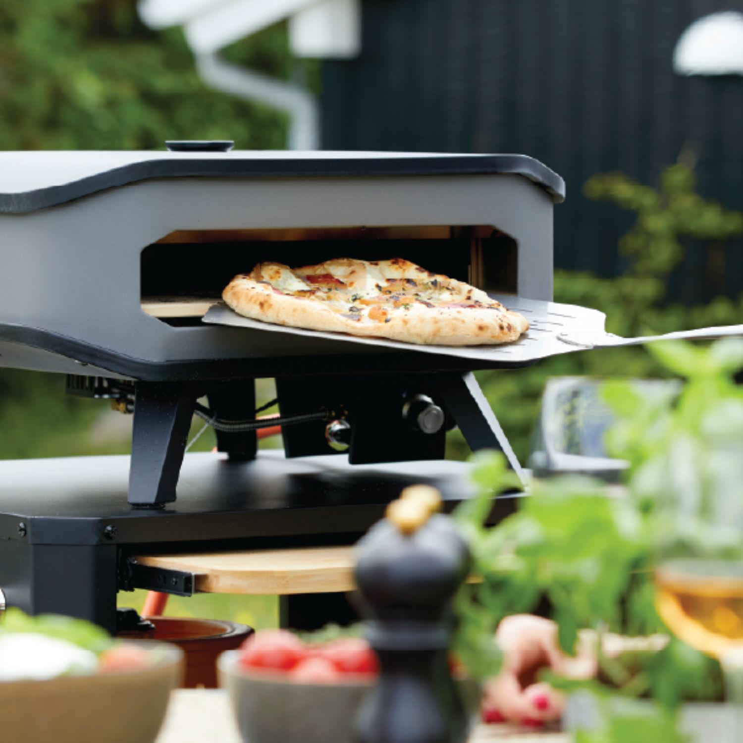 Pizza on peel outdoor gas oven